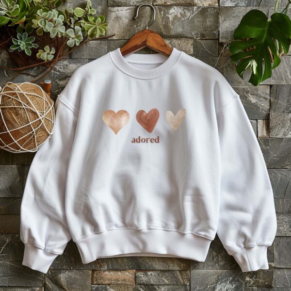 White sweatshirt with Cute Brown hearts graphic and Adored text– feminine and minimal, from Bhoomkins’ Sweatshirt collection