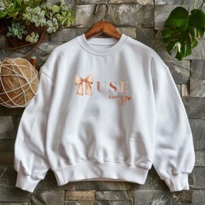 White sweatshirt with Cute Brown Bow and Muse Energy text – feminine and minimal, from Bhoomkins’ Coquette collection