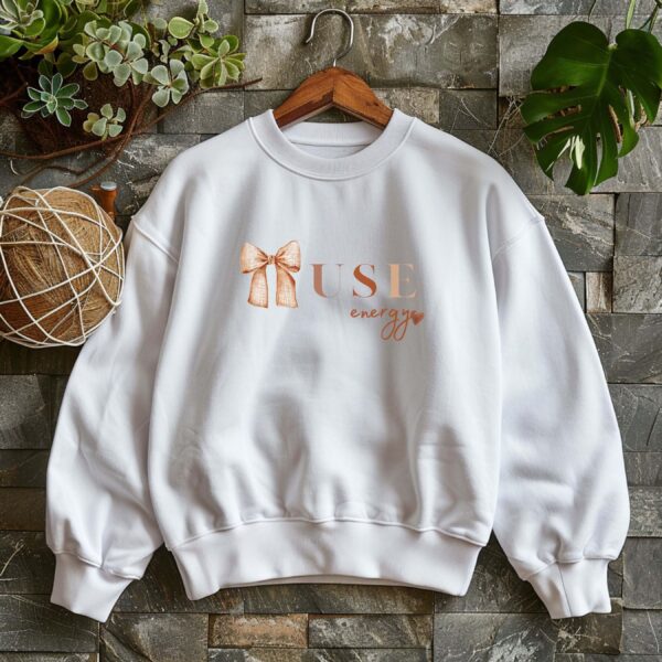 White sweatshirt with Cute Brown Bow and Muse Energy text – feminine and minimal, from Bhoomkins’ Coquette collection
