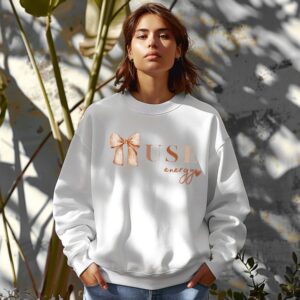 White sweatshirt with Cute Brown Bow and Muse Energy text – feminine and minimal, from Bhoomkins’ Coquette collection