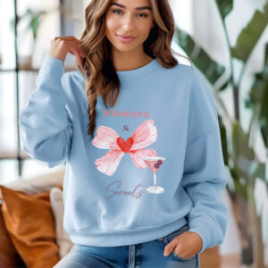 Light Blue sweatshirt with romantic bow print and ribbons and secrets text – feminine and minimal, from Bhoomkins’ Coquette collection