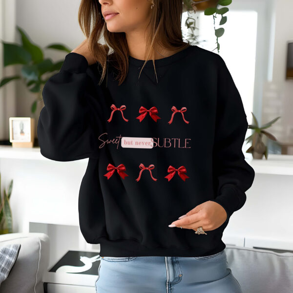Black sweatshirt with red bows print and Sweet but never subtle text– feminine and minimal, from Bhoomkins’ Coquette collection