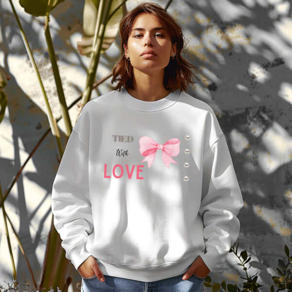 White sweatshirt with cute pink bow and pearls and Tied with Love text – feminine and minimal, from Bhoomkins’ Coquette collection